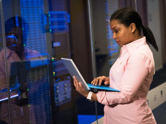 Lady with a laptop by a server